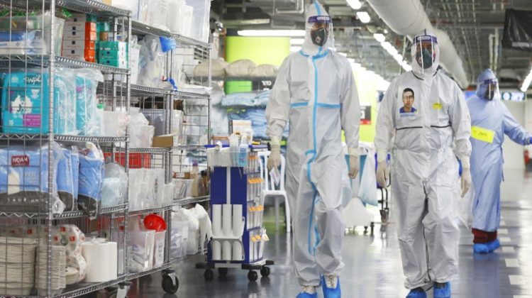 Medical staff, wearing protective equipment, walk down a corridor at the coronavirus ward of the Rambam Health Care Campus, initially build as an underground medical facility before being converted to a car park, which has been reconverted to receive patients as COVID-19 cases surge, in the northern Israeli city of Haifa on October 11, 2020. - Israel opened a new coronavirus treatment facility co-run by the army's medical corps, an unprecedented move for the military unit, aimed at bolstering an embattled healthcare system. The Jewish state currently has one of the world's highest daily coronavirus infection rates per capita, with the number of seriously ill patients steadily rising.  The army-backed unit at the Rambam Hospital in the northern city of Haifa includes a control room where patients are monitored via video and an underground coronavirus ward that used to be a car park. (Photo by JACK GUEZ / AFP) / MANDATORY MENTION OF THE LOCATION UPON PUBLICATION "Rambam Health Care Campus"