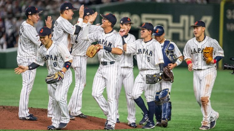 Members of team Japan celebrate their victory against Italy during the World Baseball Classic (WBC) quarter-final game at the Tokyo Dome in Tokyo on March 16, 2023. (Photo by Yuichi YAMAZAKI / AFP)