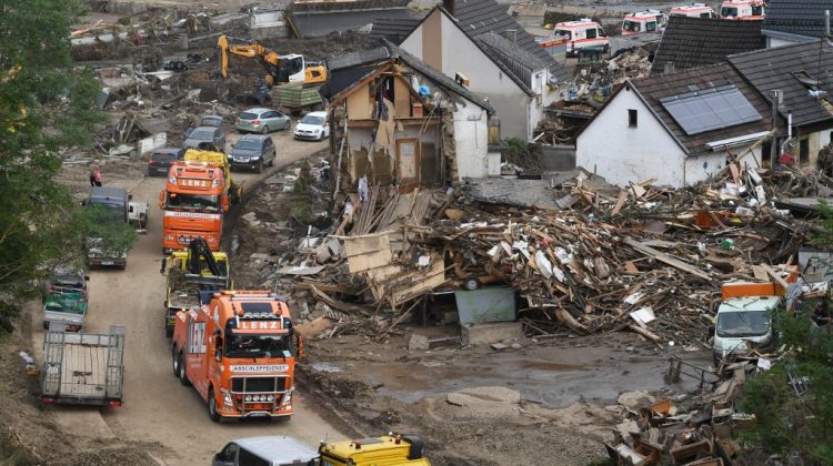 An overall view shows ambulances and rescue vehicles standing on a muddy road surrounding destroyed gouses and debris in Altenahr, Rhineland-Palatinate, western Germany, on July 19, 2021, after devastating floods hit the region. - The German government on July 19, 2021 pledged to improve the country's under-fire warning systems as emergency services continued to search for victims of the worst flooding in living memory, with at least 165 people confirmed dead. (Photo by Christof STACHE / AFP)