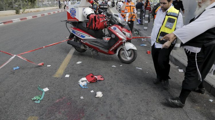 Israeli emergency personnel stand near blood stains in Jerusalem