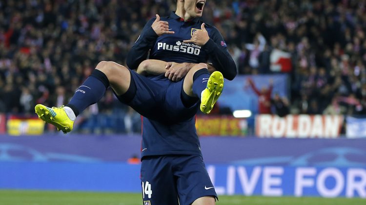 Atletico's scorer Antoine Griezmann is lifted by his teammate Atletico's Gabi Fernandez, as they celebrate the opening goal during the Champions League 2nd leg quarterfinal soccer match between Atletico Madrid and Barcelona at the Vicente Calderon stadium in Madrid, Spain, Wednesday April 13, 2016. (AP Photo/Paul White)