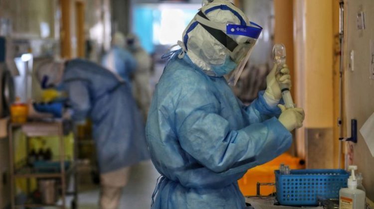 A medical staff member work at Red Cross Hospital in Wuhan in China's central Hubei province on March 11, 2020. - China announced on March 11 that key companies will be allowed to resume work in coronavirus-hit Wuhan, in another sign authorities are confident the quarantined city is winning its battle against the epidemic. (Photo by STR / AFP) / China OUT