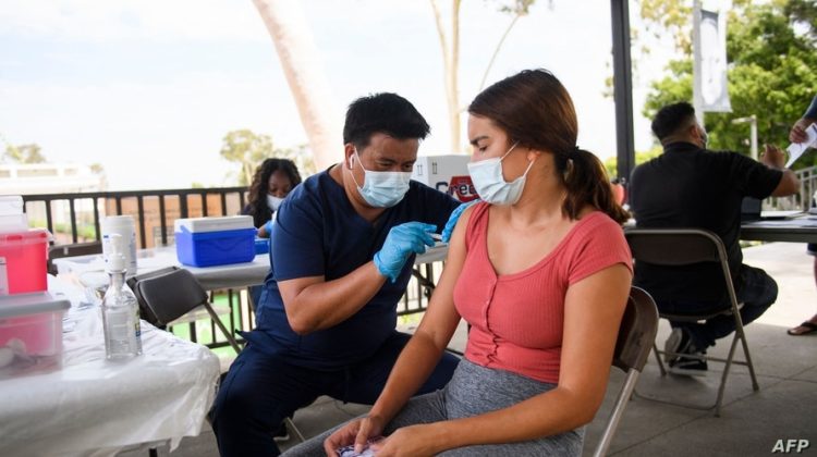 A CSULB student receives a first dose of the Pfizer Covid-19 vaccine during a City of Long Beach Public Health Covid-19 mobile vaccination clinic at the California State University Long Beach (CSULB) campus on August 11, 2021 in Long Beach, California. - Students, staff, and faculty at the California State University (CSU) and University of California (UC) system schools will be required to be fully vaccinated in order to attend in-person classes. All teachers in California will have to be vaccinated against Covid-19 or submit to weekly virus tests, the state's governor announced June 11, as authorities grapple with exploding infection rates. (Photo by Patrick T. FALLON / AFP)