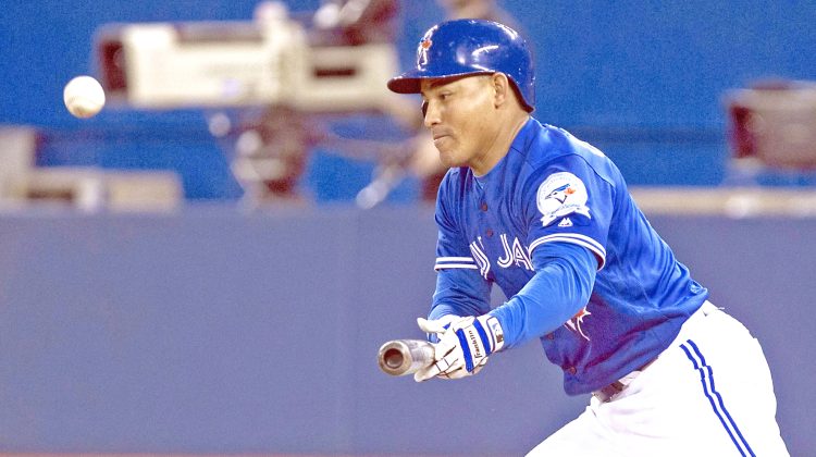 Toronto Blue Jays Ezequiel Carrera bunts during the second inning of a baseball game against the Oakland Athletics in Toronto on Saturday, April 23, 2016. (Chris Young/The Canadian Press via AP) MANDATORY CREDIT