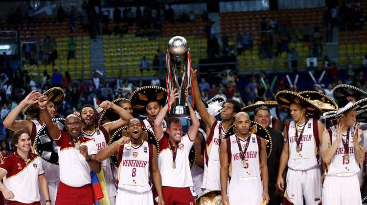 Venezuela's head coach Garcia and his players celebrate with their trophy after defeating Argentina during their 2015 FIBA Americas Championship final basketball game in Mexico City
