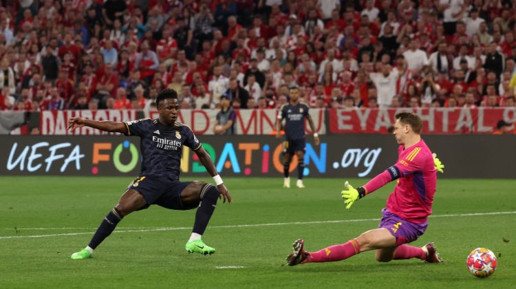 MUNICH, GERMANY - APRIL 30: Vinicius Junior of Real Madrid scores his team's first goal past Manuel Neuer of Bayern Munich during the UEFA Champions League semi-final first leg match between FC Bayern München and Real Madrid at Allianz Arena on April 30, 2024 in Munich, Germany. (Photo by Alexander Hassenstein/Getty Images)