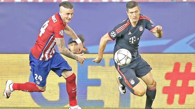Atletico's Gimenez, left, and Bayern's Robert Lewandowski challenge for the ball during the Champions League 1st leg semifinal soccer match between Atletico Madrid and Bayern Munich at the Vicente Calderon stadium in Madrid, Spain, Wednesday, April 27, 2016. (AP Photo/Paul White)