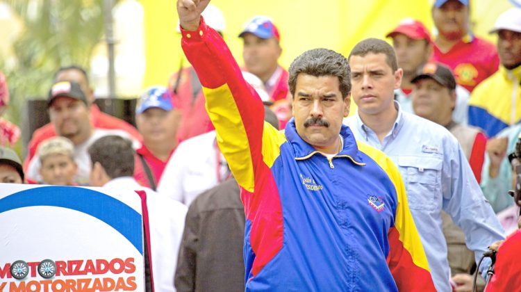 Venezuela's President Nicolas Maduro cheers during a motorcycle rally organized in support of the government in Caracas, Venezuela, Monday, Feb. 24, 2014. Since Feb. 12, opponents of President Nicolas Maduro have been staging countrywide protests that the government says have resulted in scores of deaths deaths and more than one hundred injured. The demonstrators blame Maduro's administration for the country's high crime rate and economic troubles. (AP Photo/Rodrigo Abd)