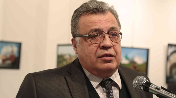 The Russian Ambassador to Turkey Andrei Karlov speaks a gallery in Ankara Monday Dec. 19, 2016. A gunman opened fire on Russia's ambassador to Turkey Karlov at a photo exhibition on Monday. The Russian foreign ministry spokeswoman said he was hospitalized with a gunshot wound. (AP Photo/Burhan Ozbilici)
