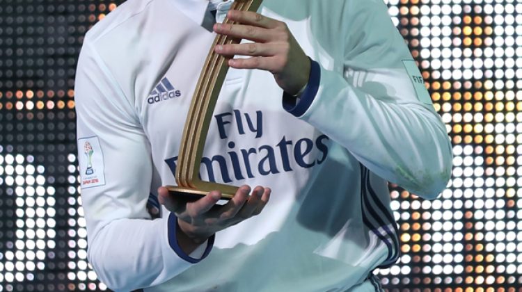 Real Madrid forward Cristiano Ronaldo receives the Golden Ball trophy after winning the Club World Cup football final match against Kashima Antlers of Japan at Yokohama International stadium in Yokohama on December 18, 2016. / AFP PHOTO / Behrouz MEHRI