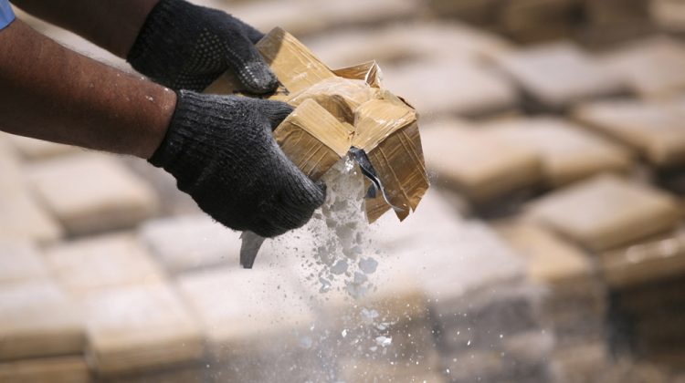 A policeman prepares seized drugs to be burned outside of Chinandega city