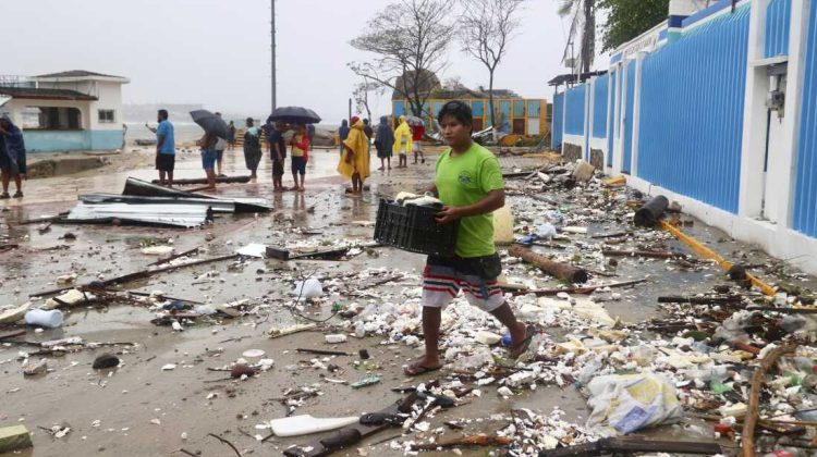 A walks through debris after Hurricane Erick hit near Puerto Escondido, Oaxaca state, Mexico, Thursday, June 19, 2025. (AP Photo/Luis Alberto Cruz)