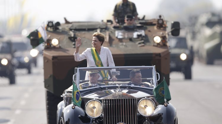 Brazil's President Dilma Rousseff waves in a vehicle during a civic-military parade to commemorate Brazil's Independence Day in Brasilia