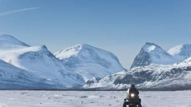 kim-walker-snowmobiling-in-kalix-river-valley-with-snow-covered-mountains-kiruna-region-arctic-sweden_a-g-8744124-4990875.jpg_2146228369