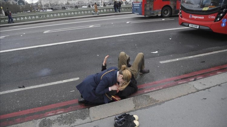 A woman assist an injured person after an incident on Westminster Bridge in London  March 22  2017   REUTERS Toby Melville